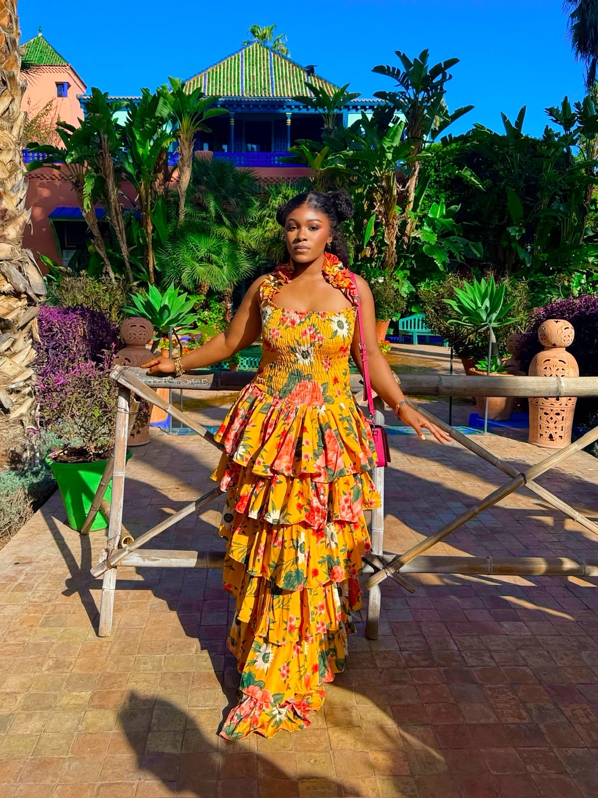 Woman wearing a bright orange African print outfit by ANCARA